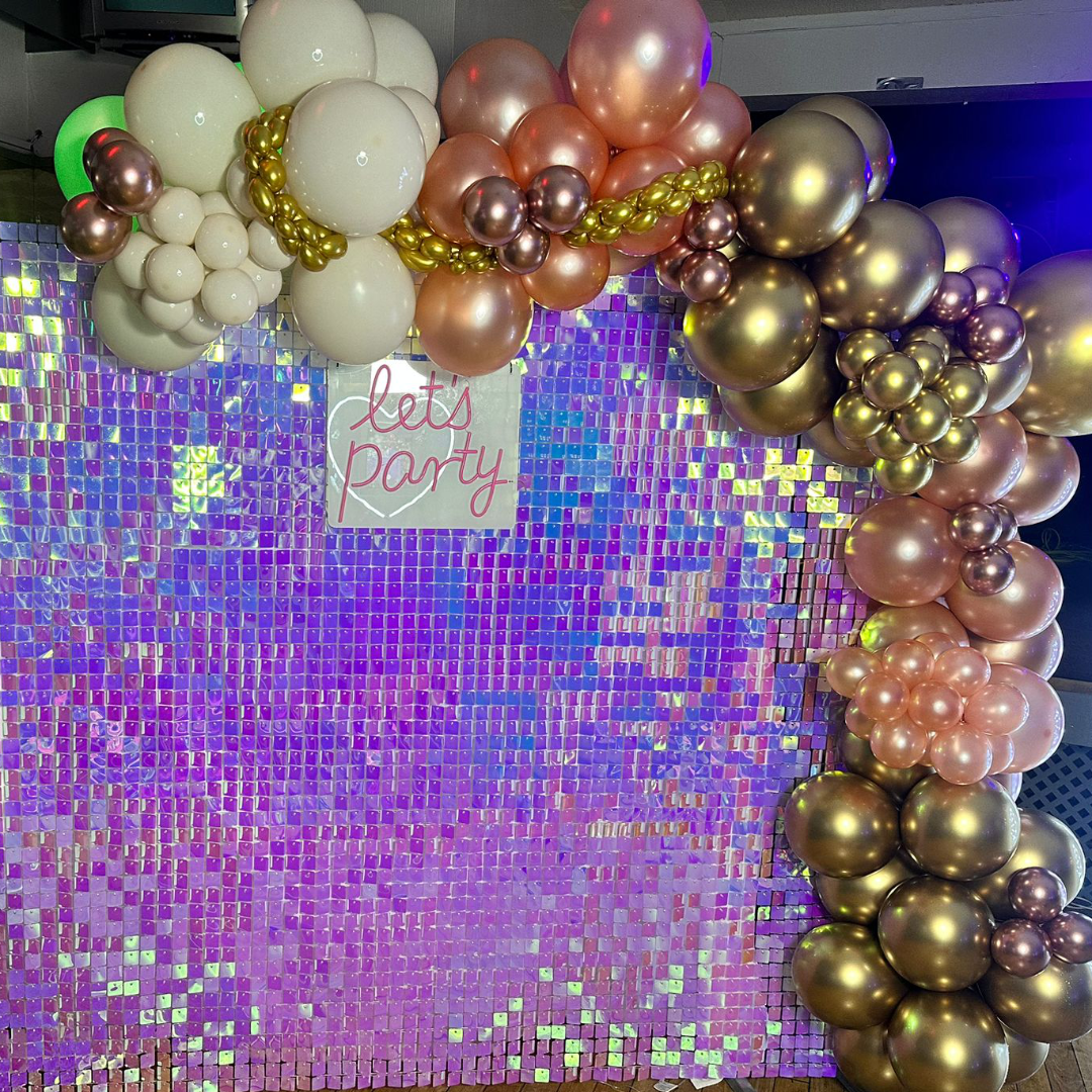 Holographic glitter wall with pink and gold balloon display