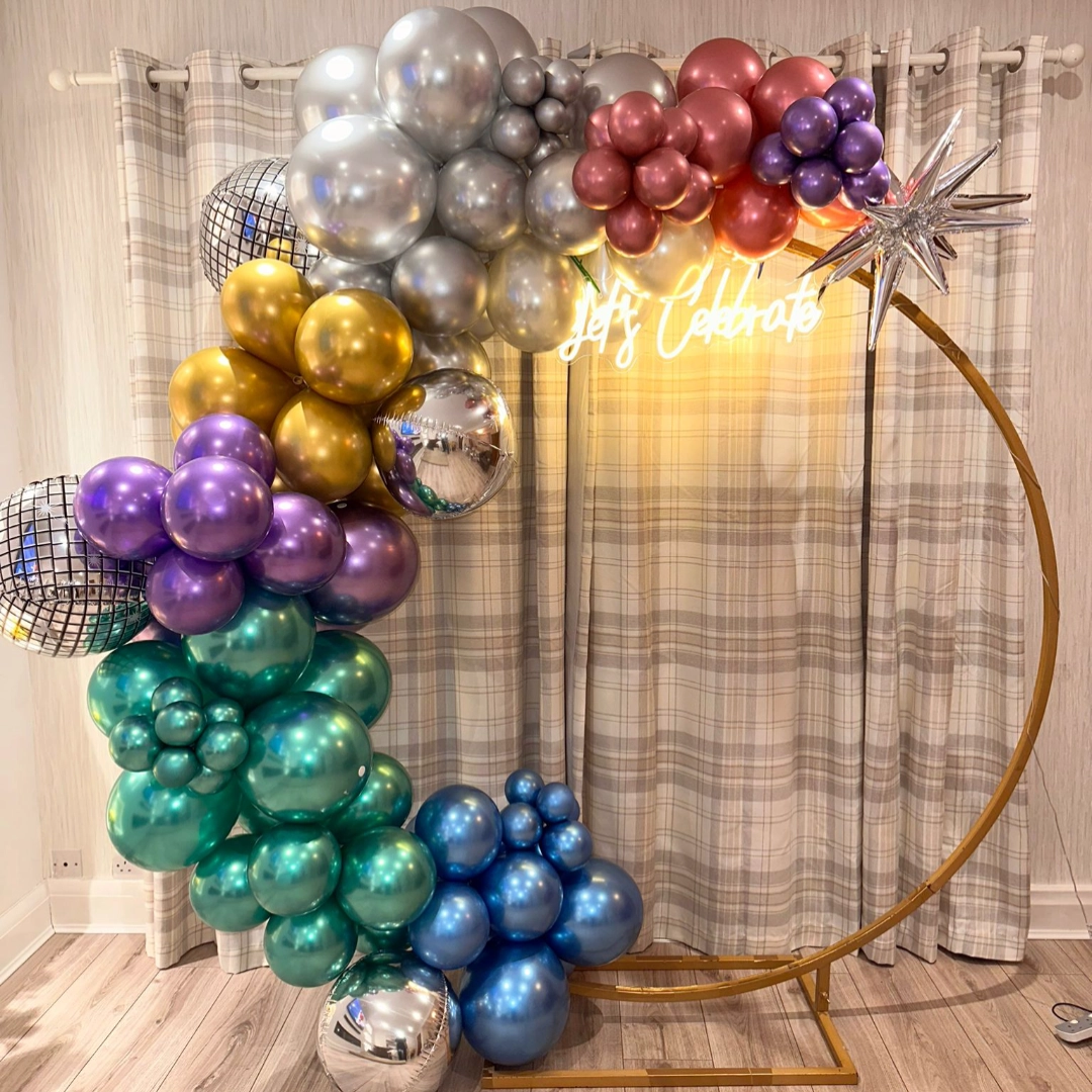 Balloons on hoop frame with neon let's celebrate sign